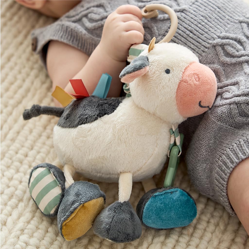 Itzy Ritzy Link & Love Toy for Stroller or Car Seat – Features Textured Ribbons, Crinkle Sounds, Clinking Rings & Silicone Teether – Designed for Ages 0 Months and Up (Cow)